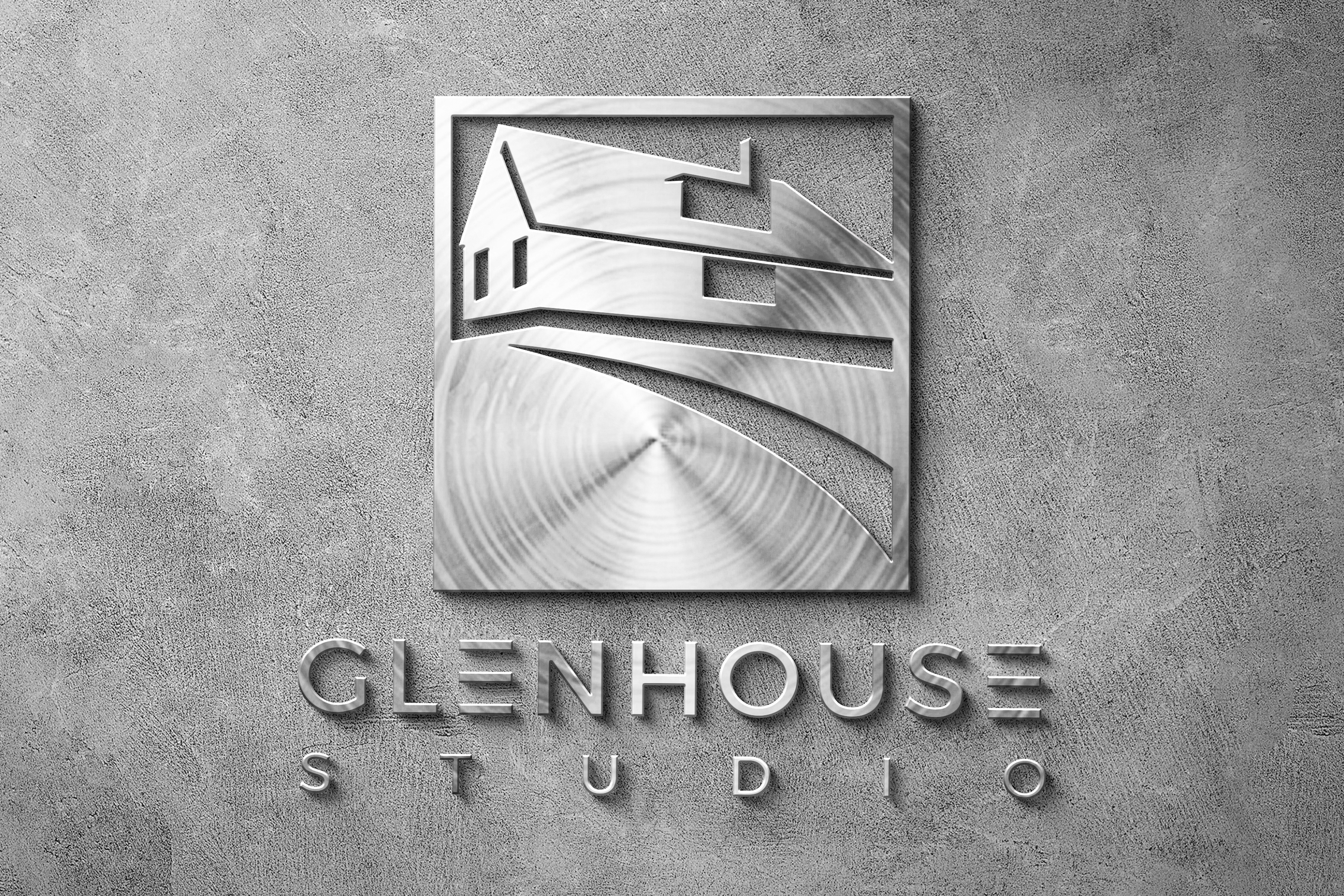 Glenhouse Studio brand mark on brushed metal signage mockup, mounted on a concrete wall