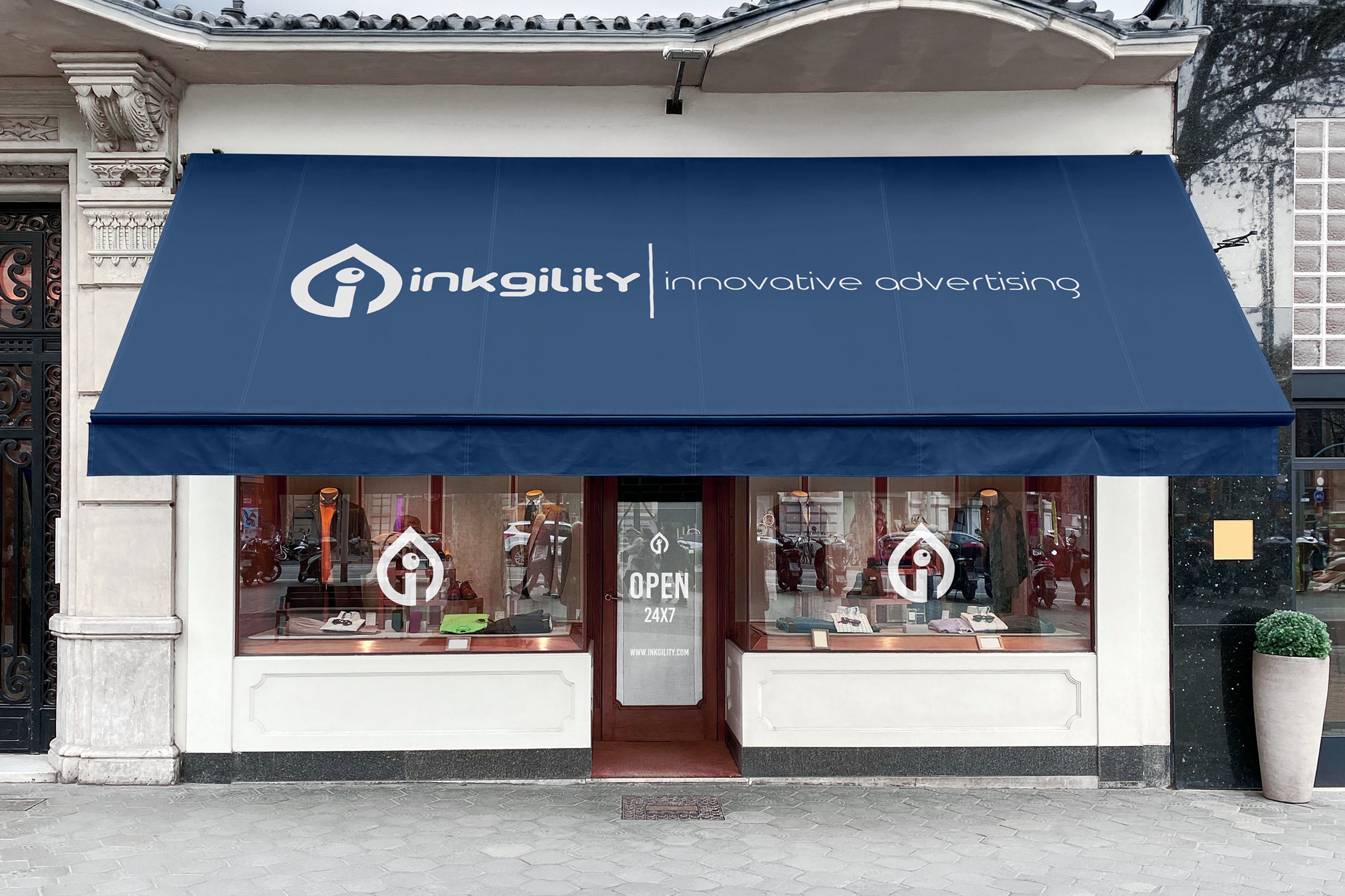 Inkgility branded awning signage mockup: fabric awning over a storefront with the Inkgility mark and wordmark